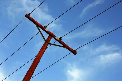 Low angle view of telephone line against blue sky