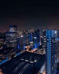 High angle view of illuminated buildings in city at night