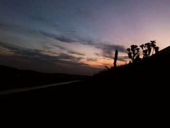 Scenic view of silhouette land against sky at sunset