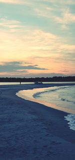 Scenic view of beach against sky during sunset