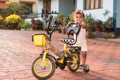 Portrait of boy riding bicycle on street