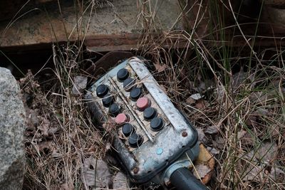 High angle view of rusty abandoned on field