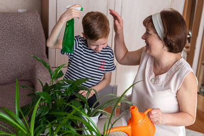 Side view of young woman giving medicine at home