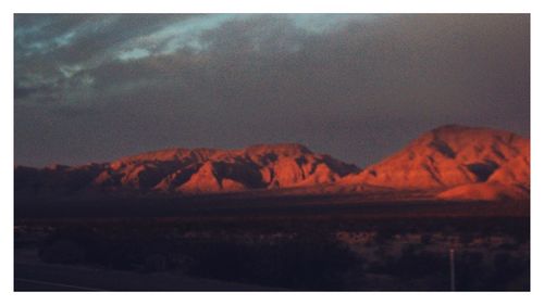 Scenic view of mountains against sky at sunset