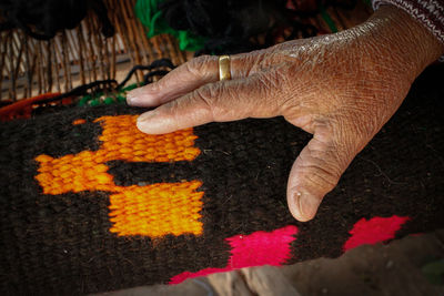 High angle view of hand touching painting