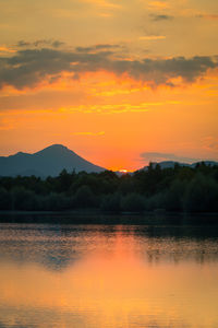 Scenic view of lake against romantic sky at sunset