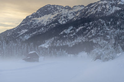 Scenic view of snow covered mountains against sky