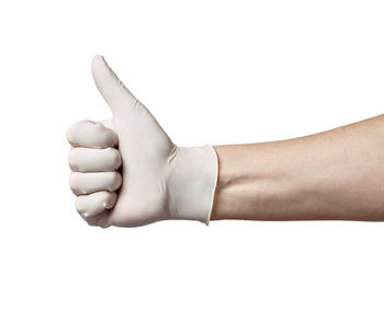 Close-up of hand with tattoo against white background