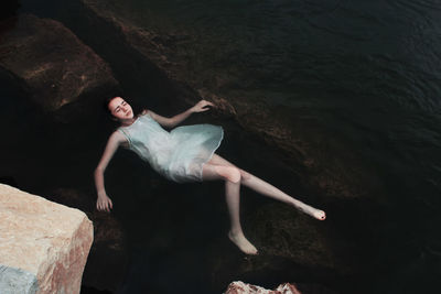 Portrait of young woman on rock