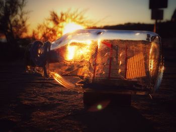 Close-up of illuminated car against sky during sunset