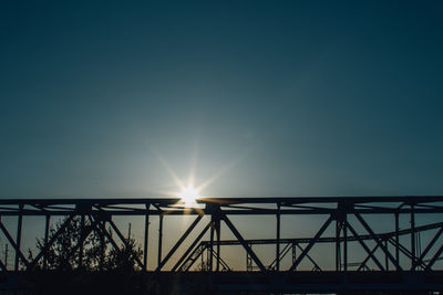 Low angle view of silhouette bridge against sky during sunset