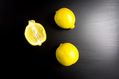 Close-up of yellow fruits against black background