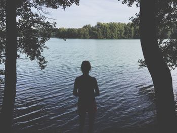 Silhouette of woman in lake