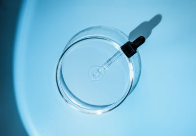 Laboratory glass petri with pipette and drop of water, serum, oil, beauty product. natural medicine