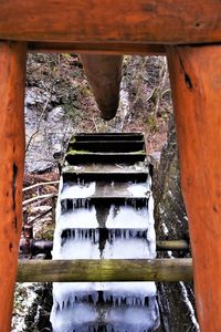 Water flowing from old rusty bridge
