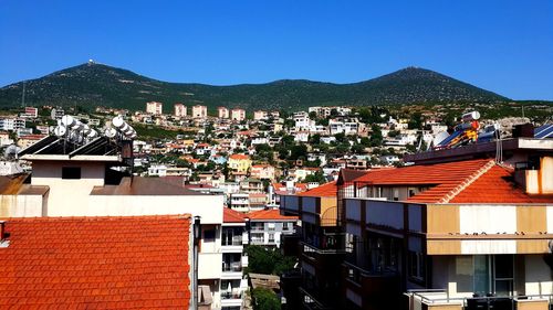 Buildings in town against clear blue sky