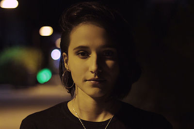 Close-up portrait of young woman at night