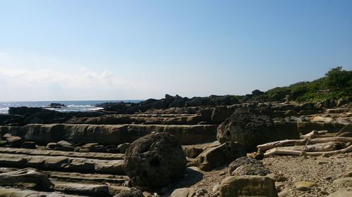 Panoramic view of sea and rocks against sky