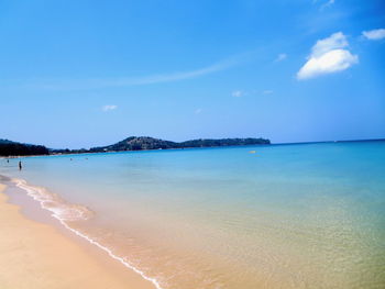 Scenic view of beach against blue sky