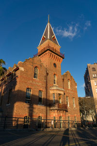 Low angle view of building against blue sky