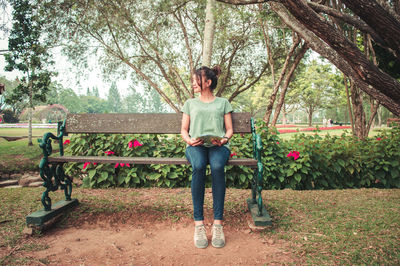 Woman sitting on park bench