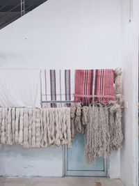 Clothes drying against white wall