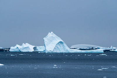 Scenic view of icebergs against sky