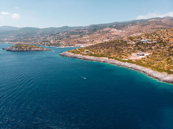 High angle view of sea and mountains against sky