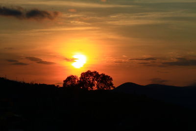 Scenic view of silhouette landscape against romantic sky at sunset