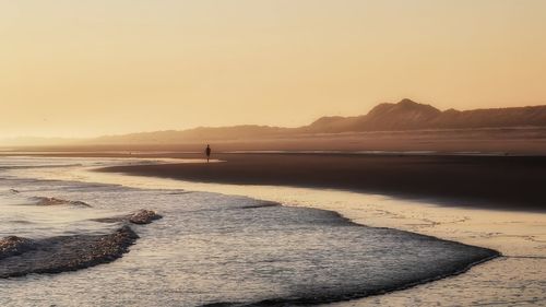 Scenic view of sea against clear sky during sunset