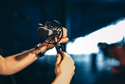 Cropped hand of musician holding microphone