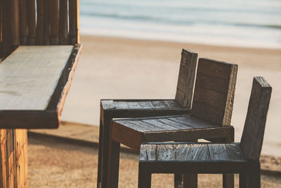 Empty chairs and table on beach