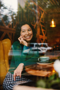 Portrait of young woman sitting at home