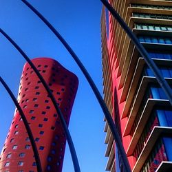 Low angle view of modern building against blue sky