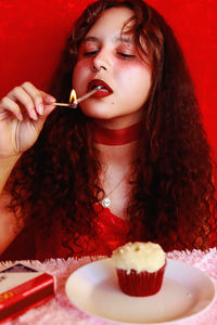 Portrait of young woman eating food