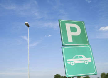 Low angle view of road sign against sky