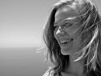 Close-up of young woman looking away at beach