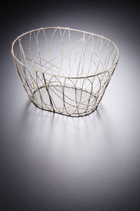 High angle view of empty yellow basket on gray table