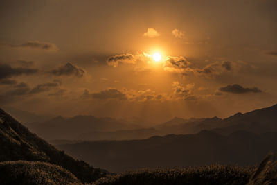 Scenic view of silhouette mountains against sky during sunset