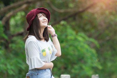 Smiling young woman standing outdoors