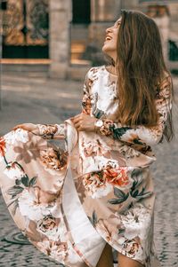Woman wearing hat while standing against plants