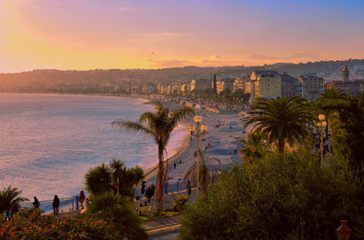 High angle view of city by sea against sky