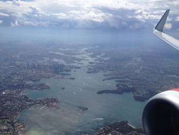 Aerial view of sea and airplane wing