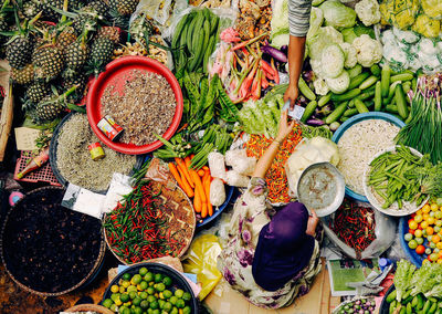 High angle view of woman selling vegetables at market