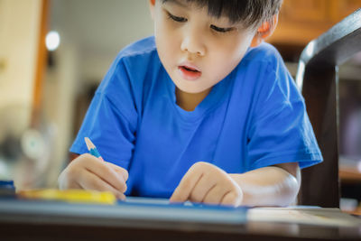 Close-up of cute girl playing in cafe