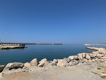 Scenic view of sea against clear blue sky