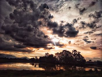 Scenic view of lake against sky during sunset