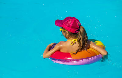 Rear view of girl in swimming pool