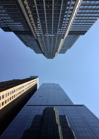 Low angle view of modern buildings against blue sky in new-york, manhattan 