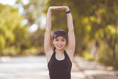 Portrait of smiling young woman standing outdoors